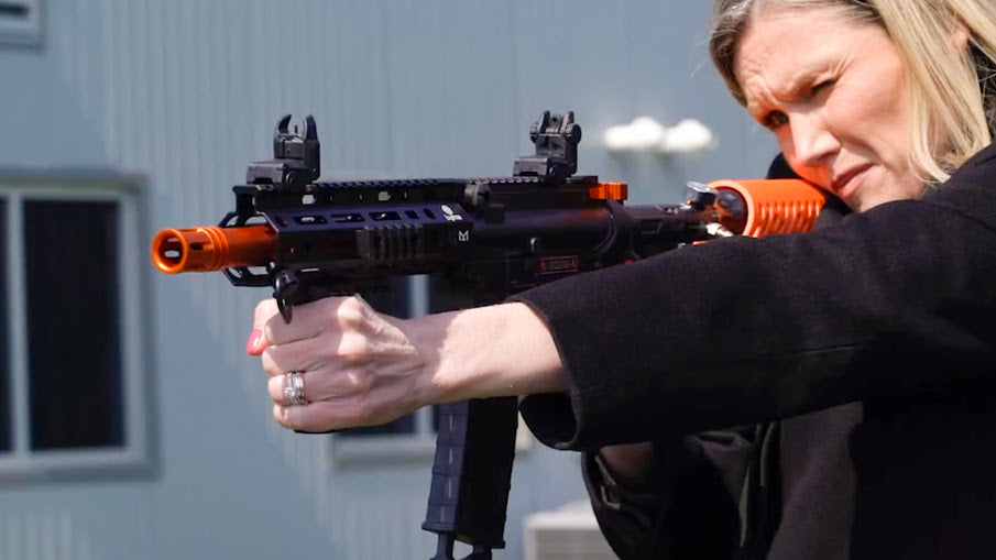 A Woman Using The Byrna Mission 4 Rifle