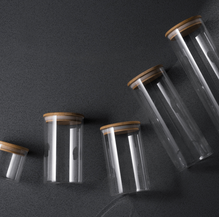 Genicook glass canisters on top of dark table