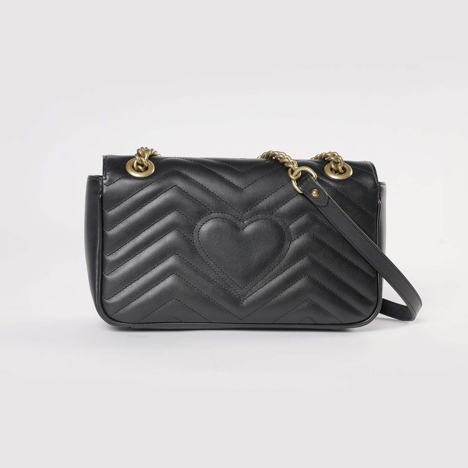 black gucci bag with heart on back