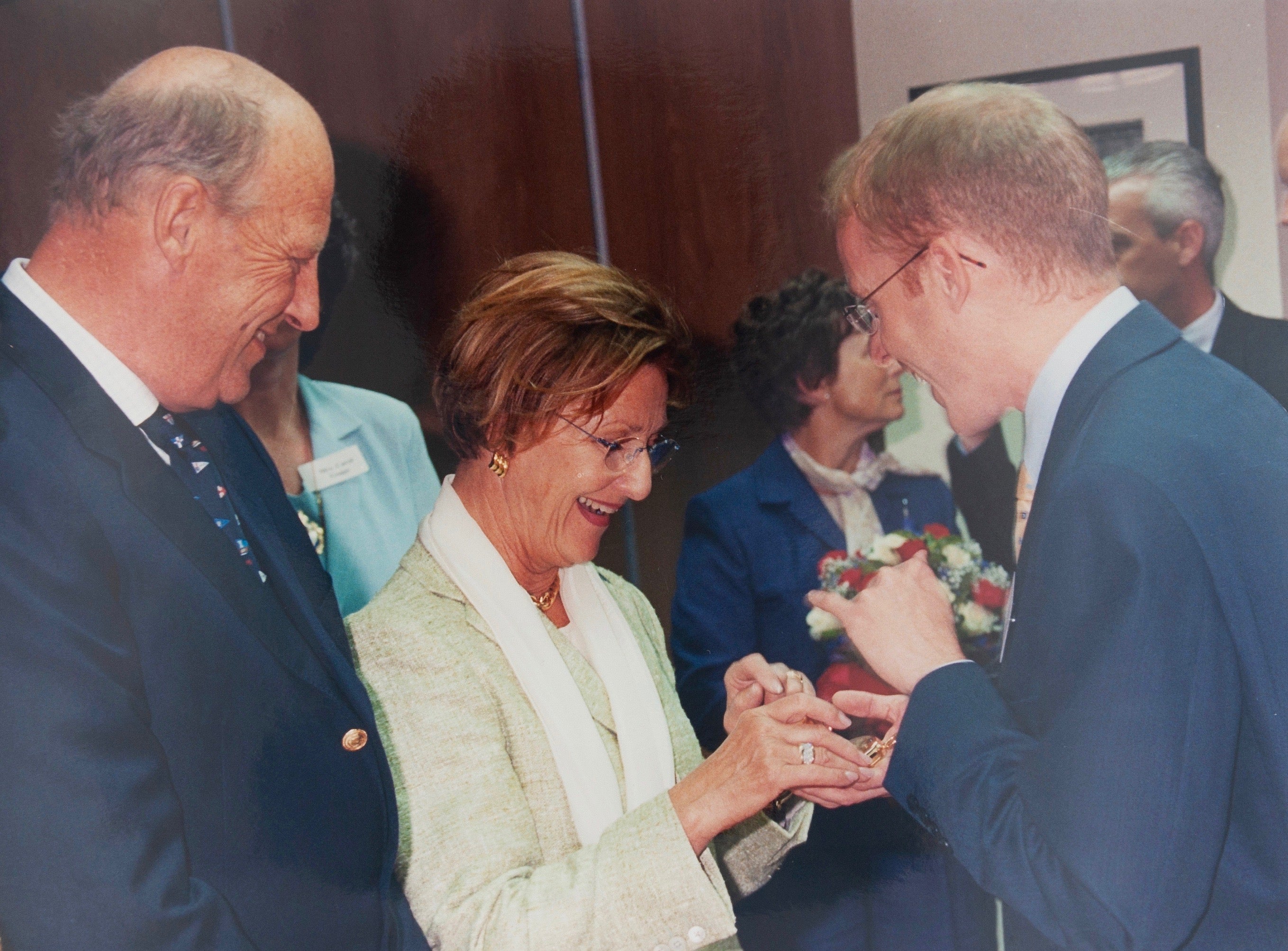Roger W. Smith watchmaker showing the King and Queen of Norway a watch on their visit to the Isle of Man for A Collected Man London