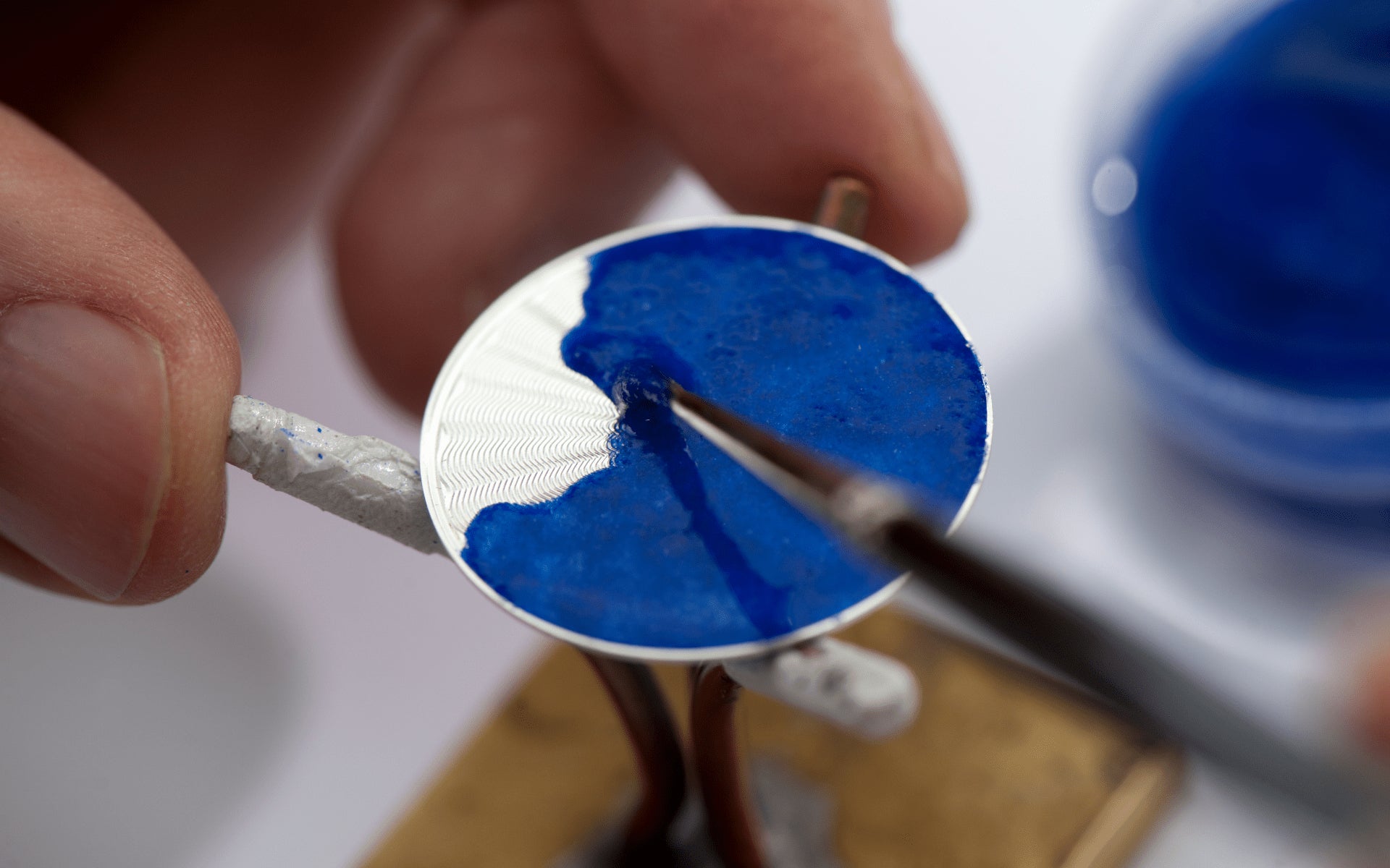 Blue enamel being painted of guillché dial in The Art of Enamel Dials for A Collected Man London