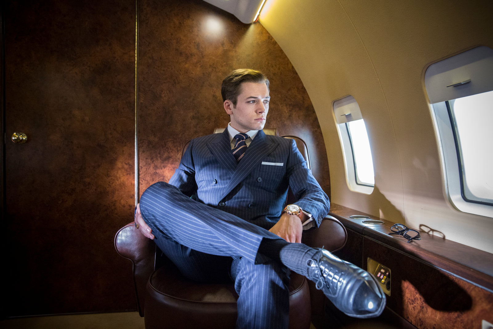 Taron Egerton on set of Kingsman: The Secret Service wearing Bremont A Collected Man London