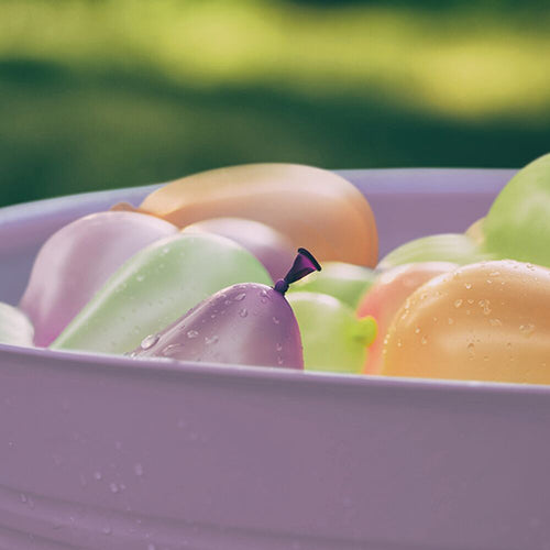 Close Up of Light Purple Metal Tub Containing Water Balloons