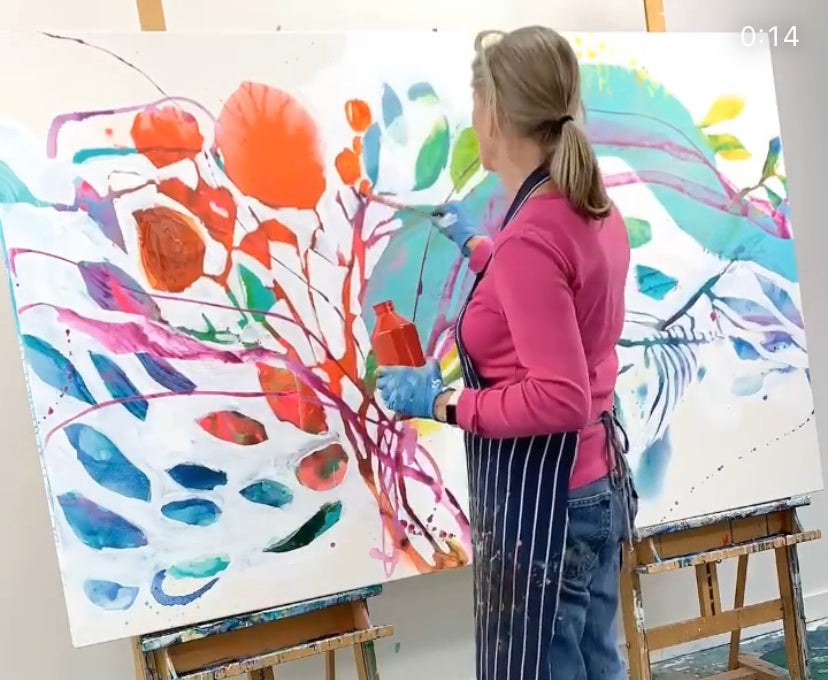 Abstract artist, Claire Desjardins, paints colourful abstract floral painting in her art studio.