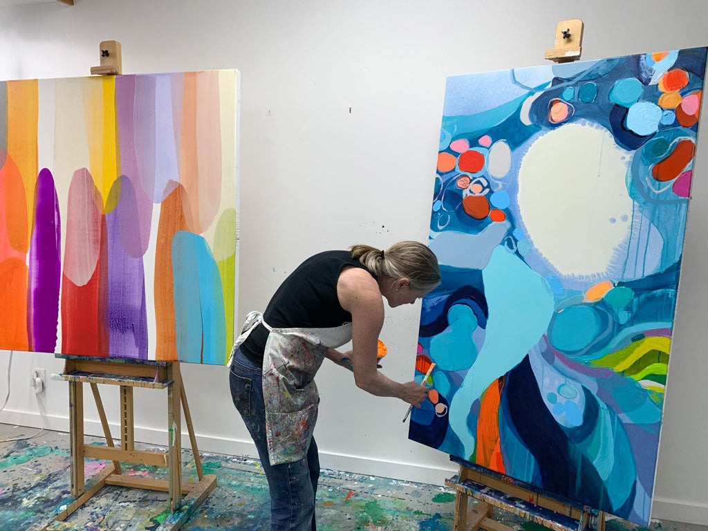 Abstract artist, Claire Desjardins, painting in her art studio.