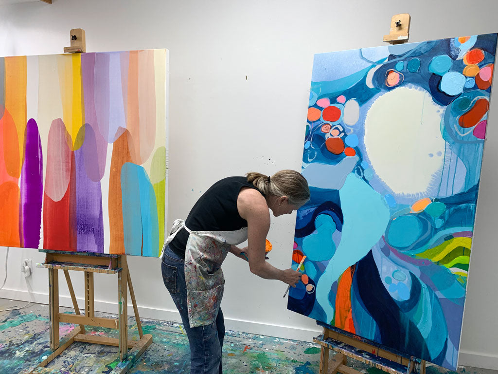 Abstract artist Claire Desjardins painting in her home studio