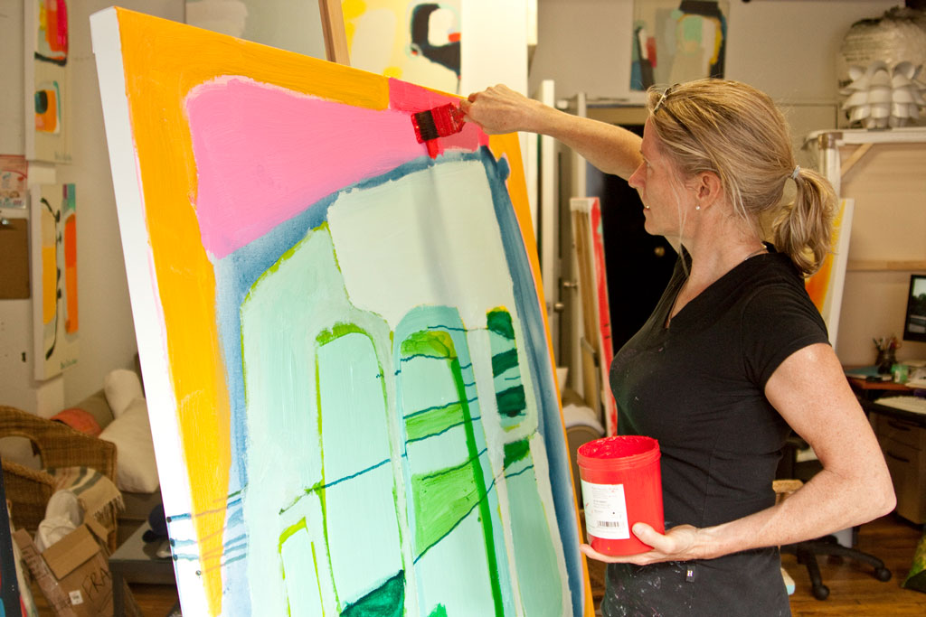 Abstract artist, painter Claire Desjardins, painting at easel in art studio.