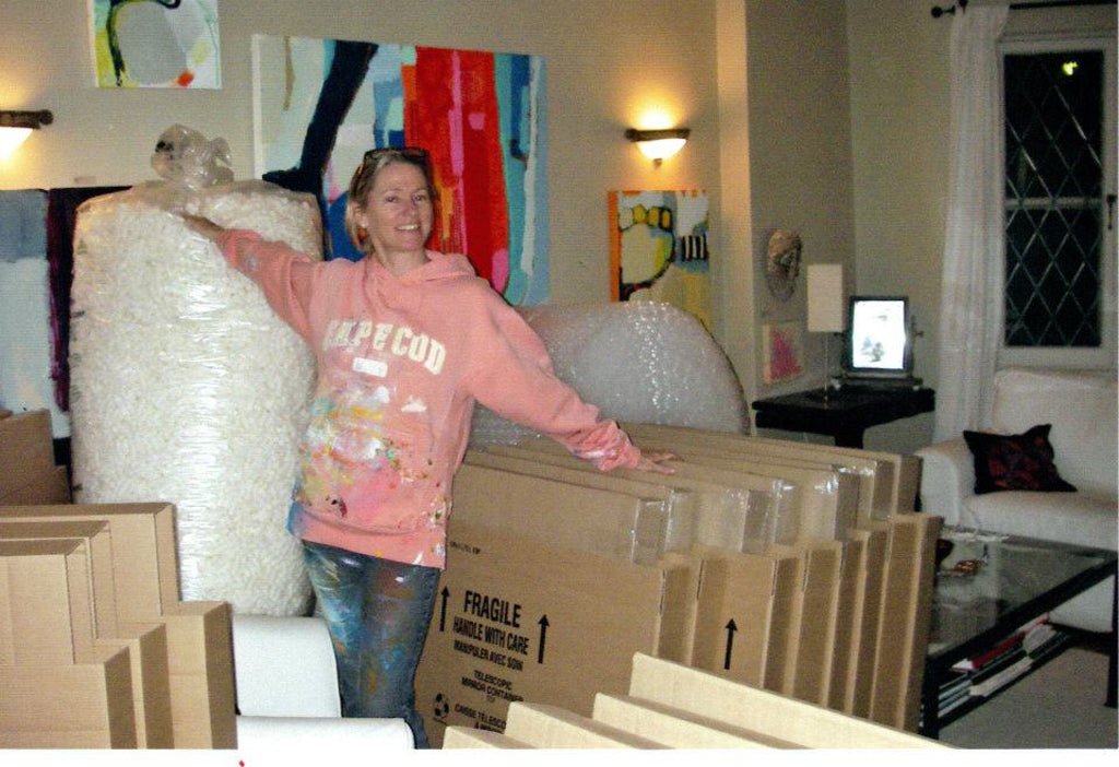 Artist Claire Desjardins, amid boxes and packing supplies, to ship her paintings in.