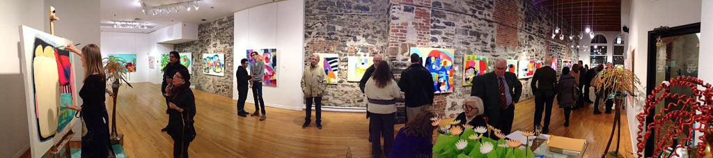 Vernissage for exhibition by painter, Claire Desjardins. Art collectors chat while artist is painting.