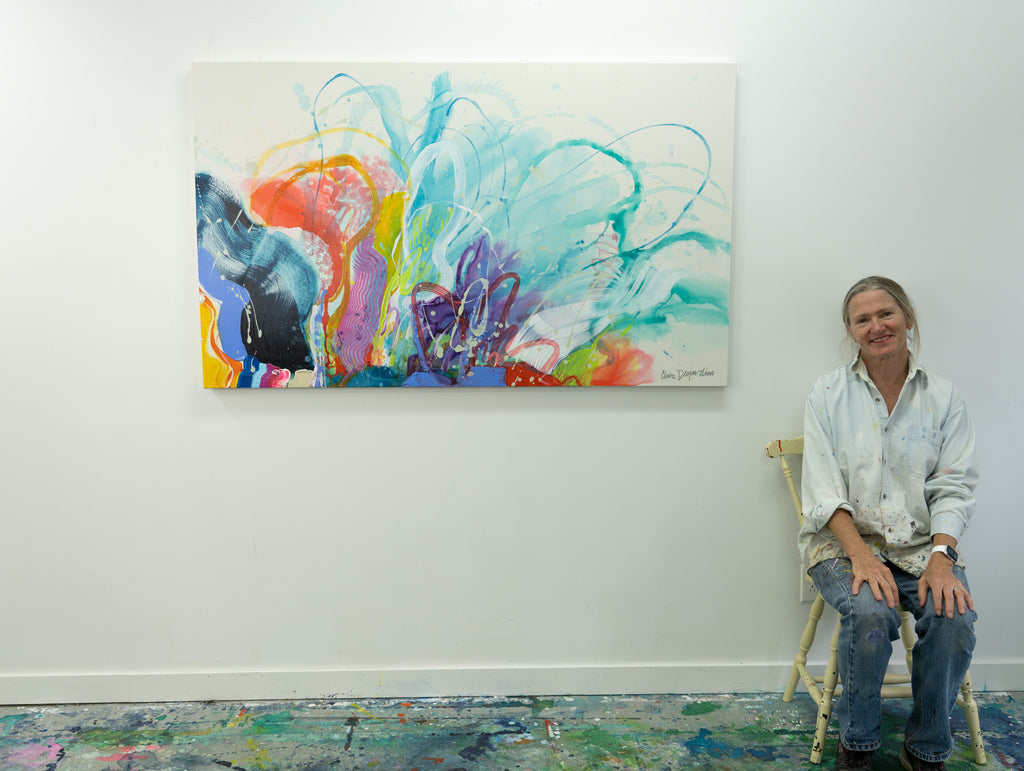 Artist Claire Desjardins sits beside her painting that was inspired by Abstract Expressionism.
