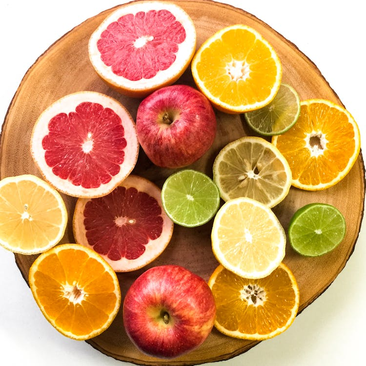 Slices of vibrant citrus fruits arranged on a plate, a colorful and refreshing display.