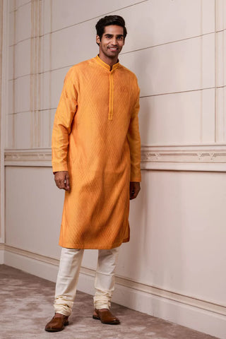A Man Wearing Orange Kurta Set