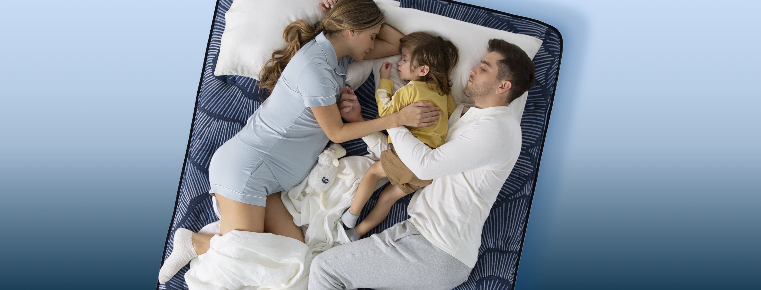 Pregnant Mom, Dad & Child all sleeping on top of a Serta Perfect Sleeper Mattress