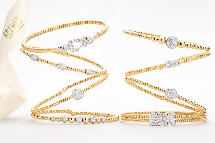 Bremer Jewelry in Peoria and Bloomington, IL | Flexible Diamond Bangle Bracelets in Yellow Gold with Bremer ribbon