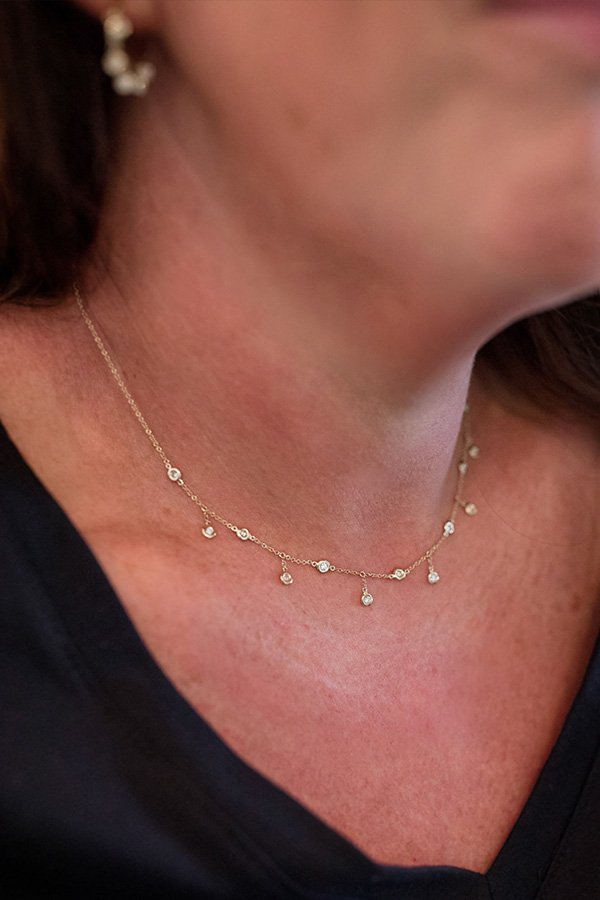 Jessica wearing Milestones Necklace with Diamond Bezel Fringe in Yellow Gold