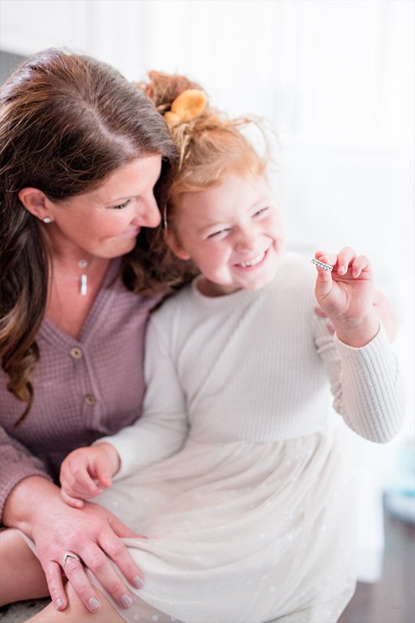 Jessica holding Sunny wearing A. Jaffe Oval Diamond Eternity Ring in White Gold