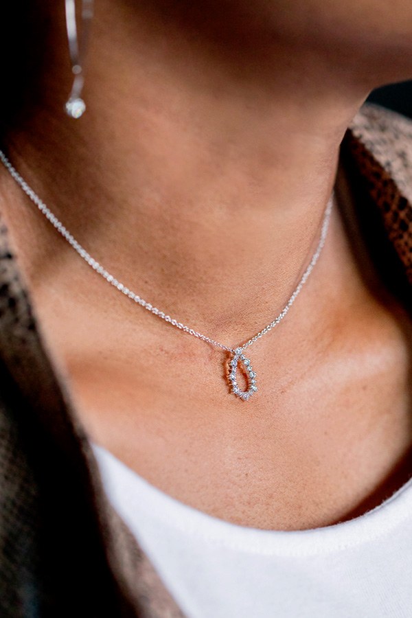 Monica wearing Open Pear-Shaped Diamond Necklace in White Gold