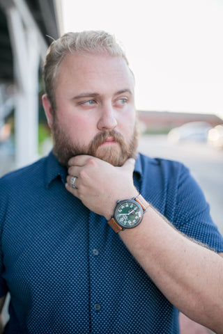 man with a luxury wedding ring and a Shinola watch