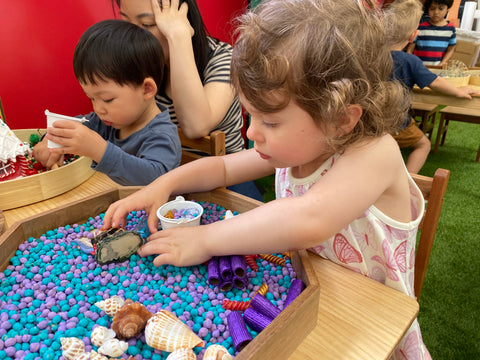 little girl playing with mermaid kit