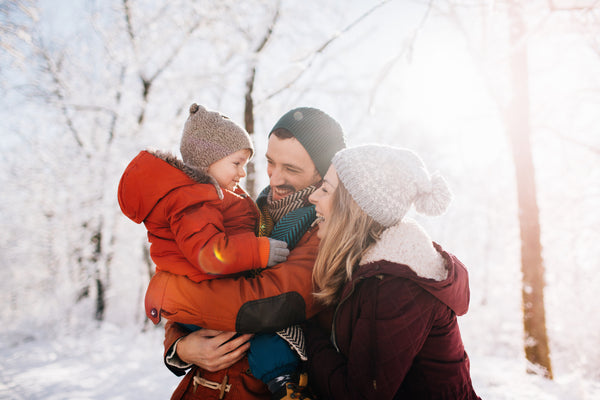 Parents and baby in snow