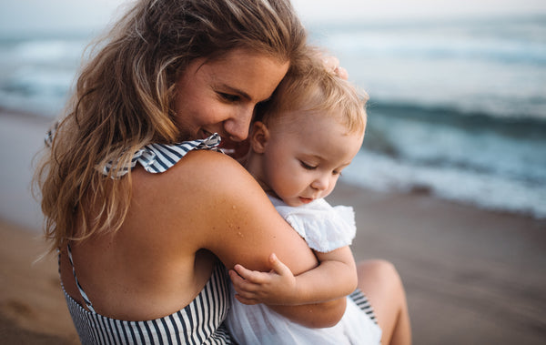 A mother and baby at the beach with baby must-haves