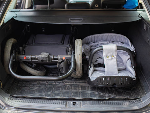 Folding a stroller into the trunk of a car