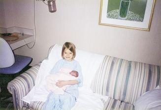Big Sister Sophia holds Alynne for the first time in the Neonatology Unit - 1997