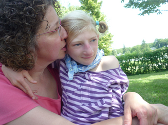 Alynne, on holiday, puts her arm around her mother's neck