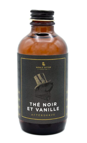 Noble Otter Black tea and vanilla aftershave splash in a brown bottle with gray and gold label showing an otter in a top hat