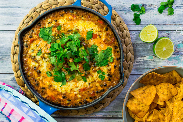 QUESO FUNDIDO SERVED WITH CHIPOTLE & LIME TORTILLA CHIPS