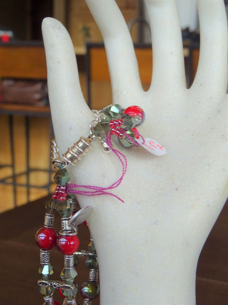 Hand beaded bracelet with red-grey beads and silver separators