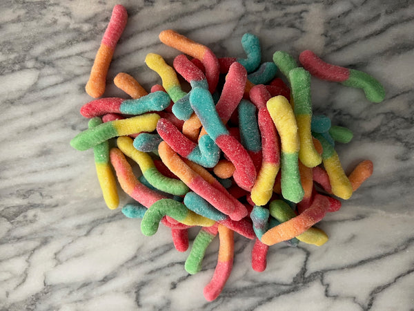Sour Gummy Worms on Marble Counter Top