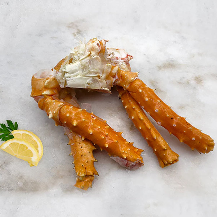 King Crab Center Cut on marble with lemon and herbs