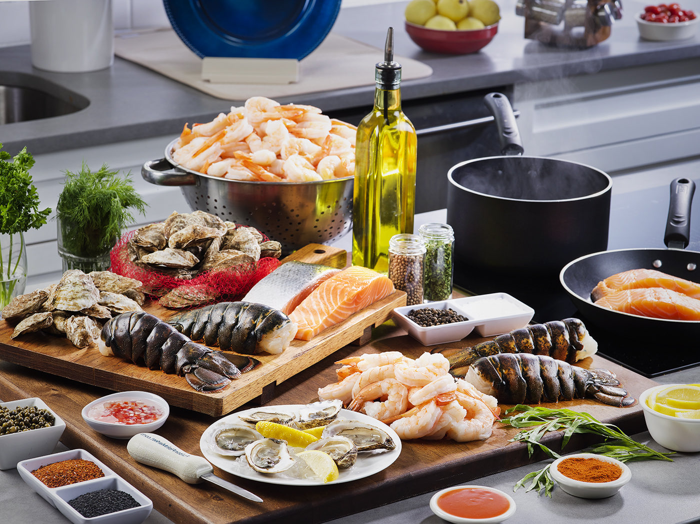 Seafood Spread on Kitchen Counter with Oil, Herbs, Spices, Lemons and Pots and Pans