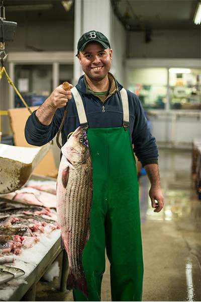 Fishmonger with Whole Striped Bass