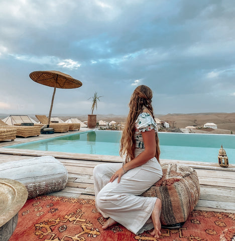 girl with long blonde hair and braid posing at the selina agafay nomad camp in morocco