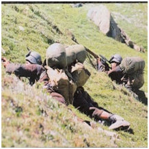 Valorous Indian Soldiers taking cover and firing shots at the  bunkers uphill.