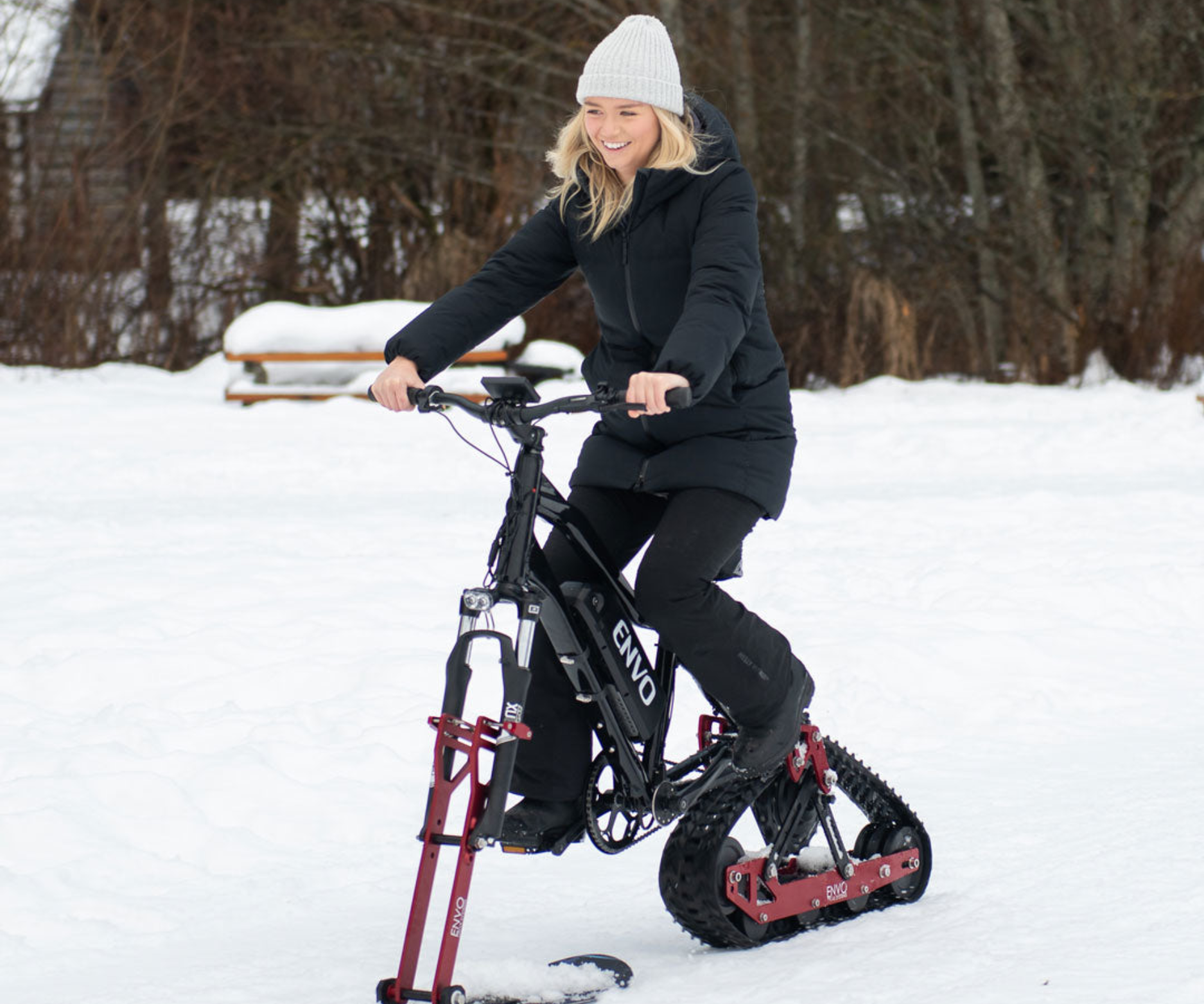 A happy young woman riding her ENVO snow bike | EBIKEBC