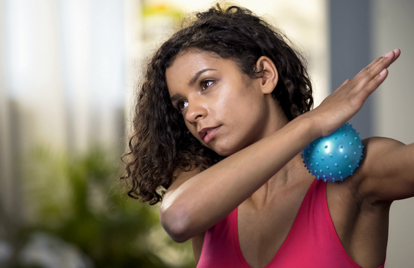 Massage ball being used on sholders