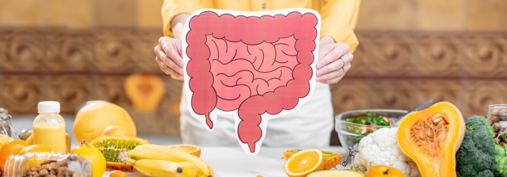 Woman holding graphic digestive system