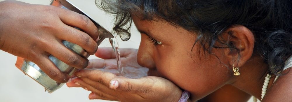 Girl drinking water from cup