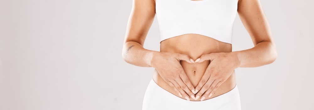 Woman holding gut area