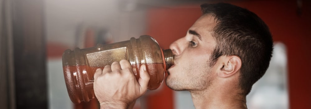 man drinking pre workout