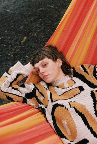 girl in hammock wearing knitted jumper