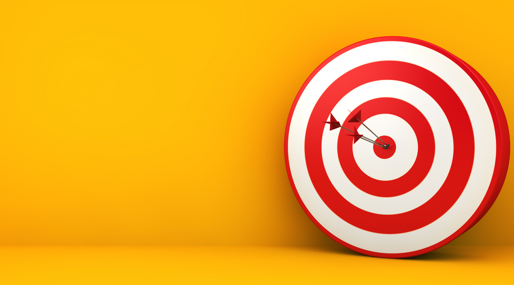 A perfectly aimed red and white dart finds its mark at the center of a target, symbolizing precision and hitting the bullseye in video marketing.