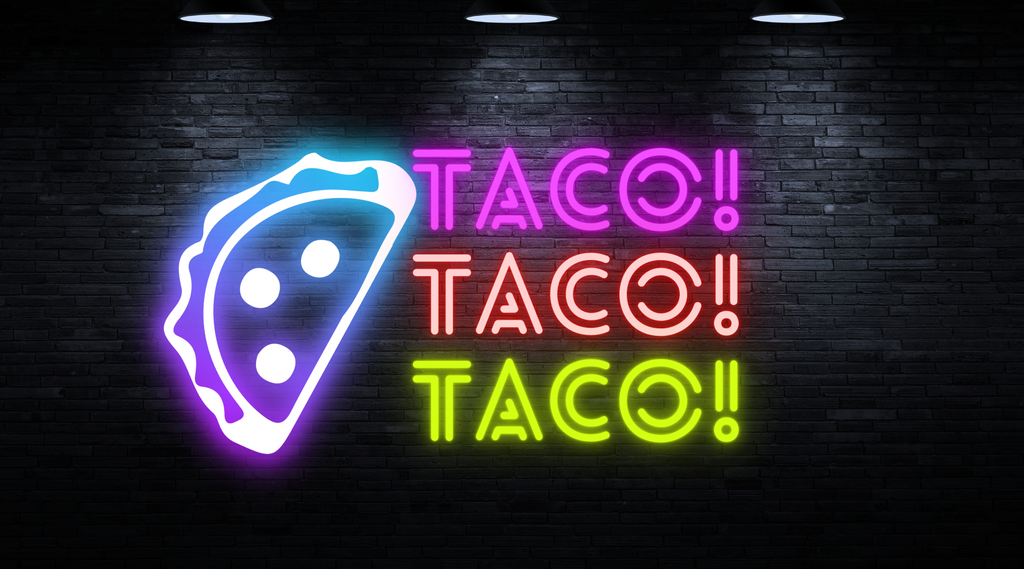 a neon sign on a brick wall that says taco