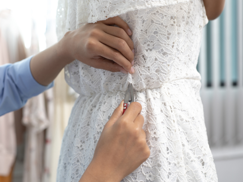 Wedding gown alteration - seamstress cutting