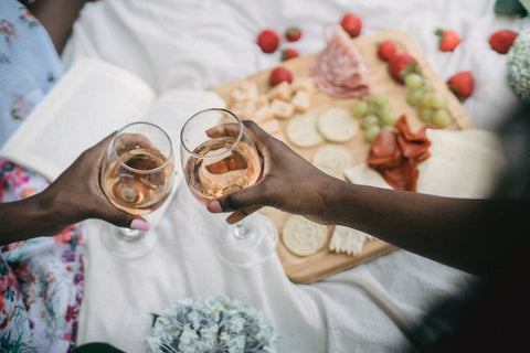 two people toasting with wineglasses in valentine's day setting