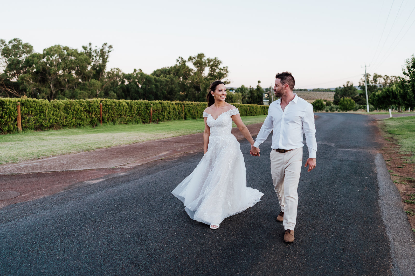 Sami & Marty walking down the road at their Sittella Winery wedding