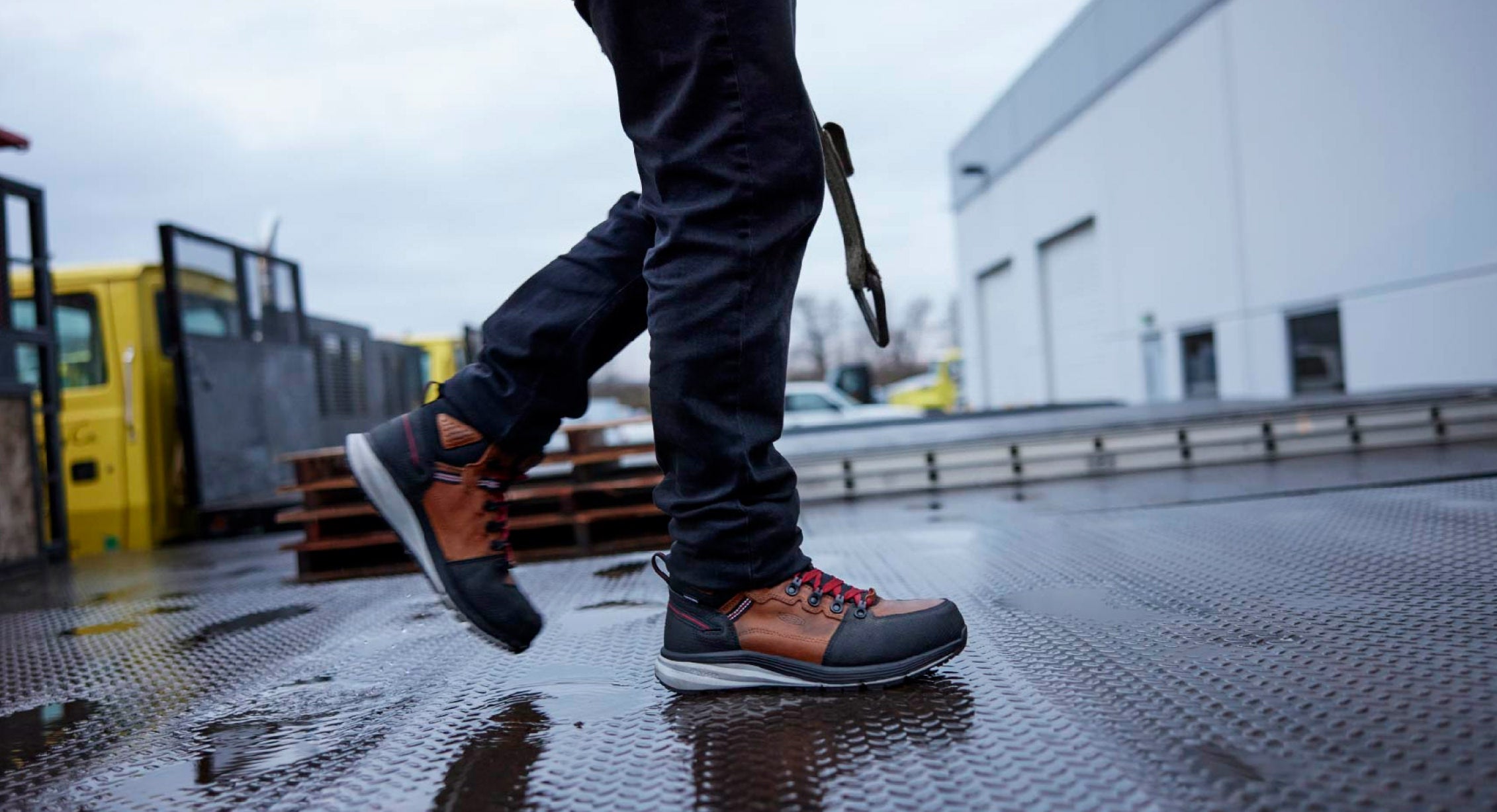 Warehouse worker walking on wet concrete in Red Hook work boots